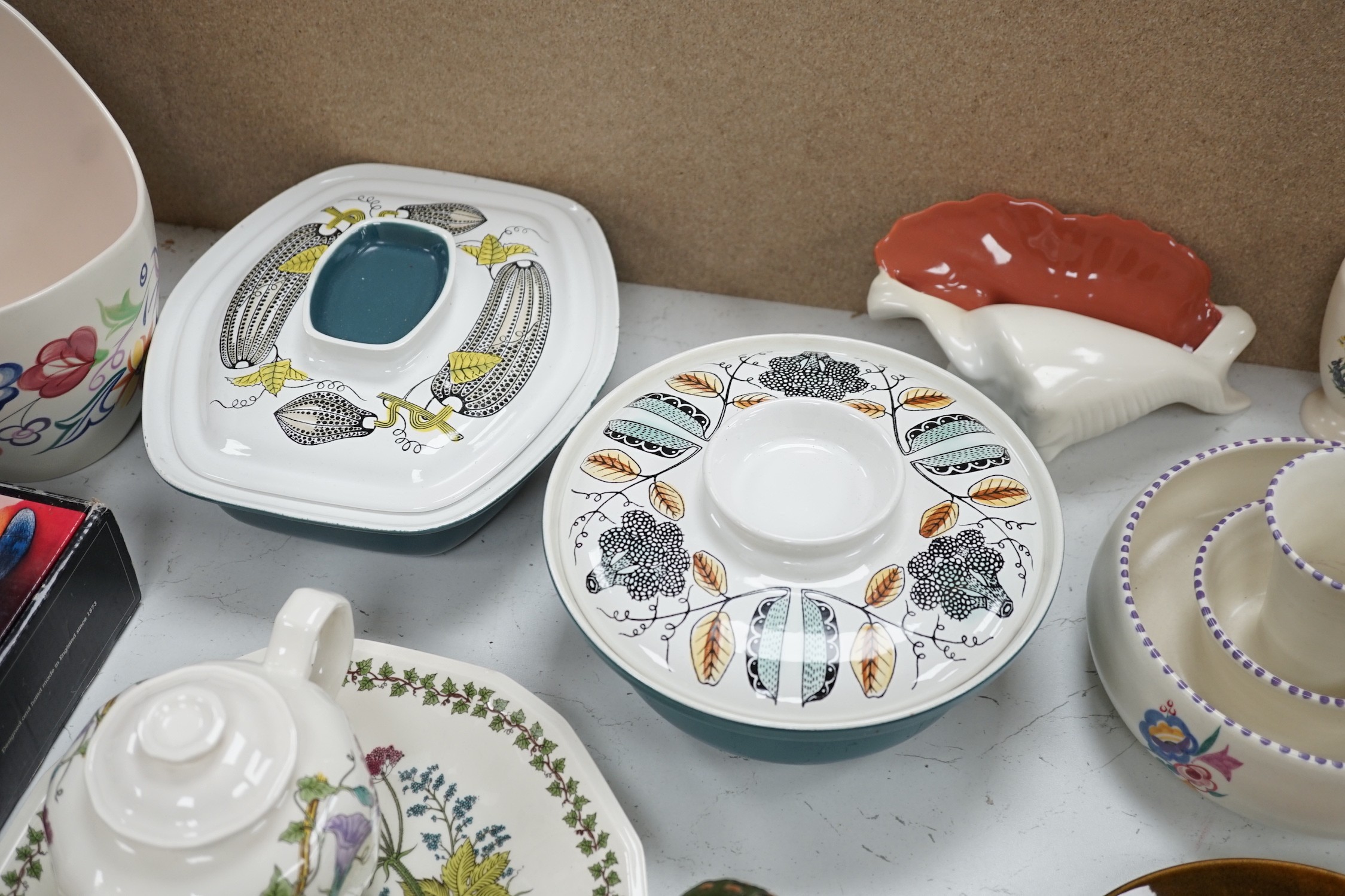 A collection of Poole pottery teapots, plates etc.